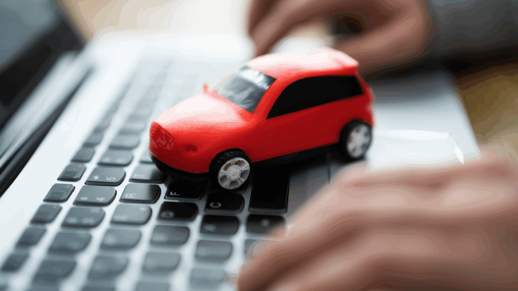 Online-Abfrage Fahreignungsregister Flensburg – rotes Auto auf Laptop-Tastatur symbolisiert digitale Punkteabfrage für Autofahrer